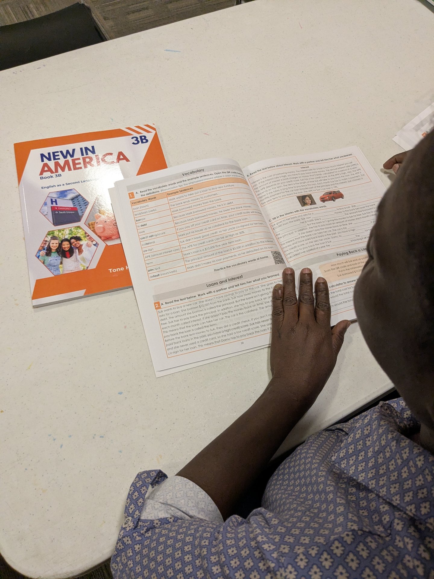 A student studying the Loans and Interest vocabulary spread in a Level 3B workbook